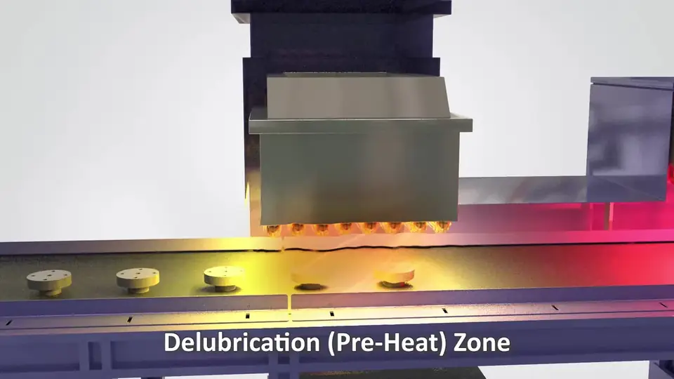 Cutaway of the delubrication zone of a sintering furnace with parts on a mesh belt